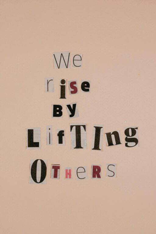 Motivational words on cutouts forming an uplifting message on a beige background.